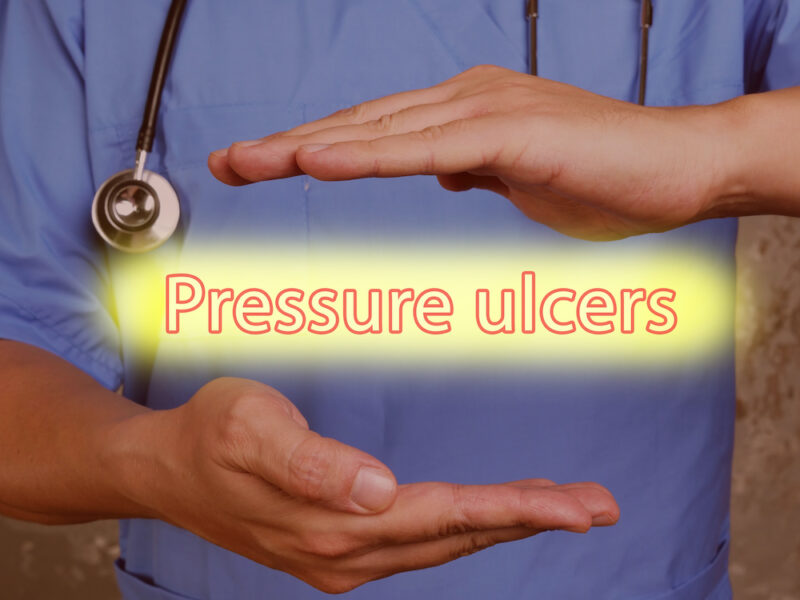 Conceptual photo about Pressure ulcers pressure sores with handwritten text.