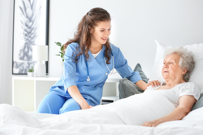 Medical worker with senior woman in nursing home